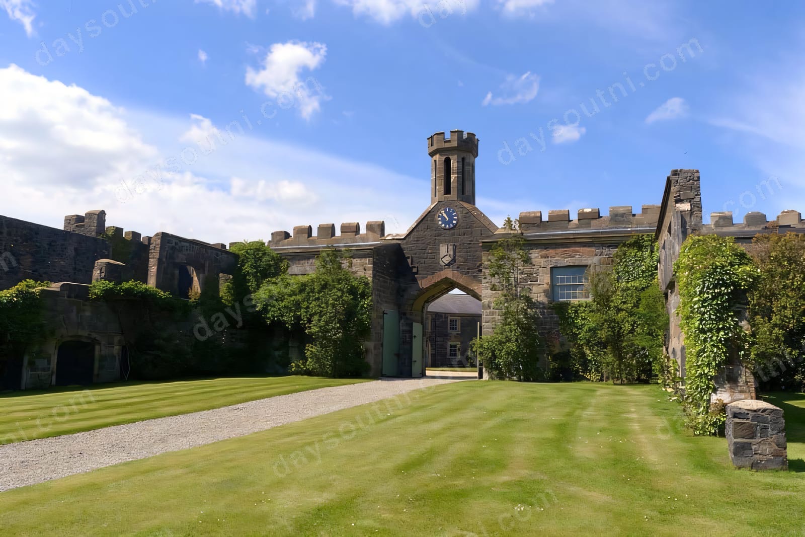 Lissanoure Castle's battlemented courtyard and clock tower above a broad green lawn