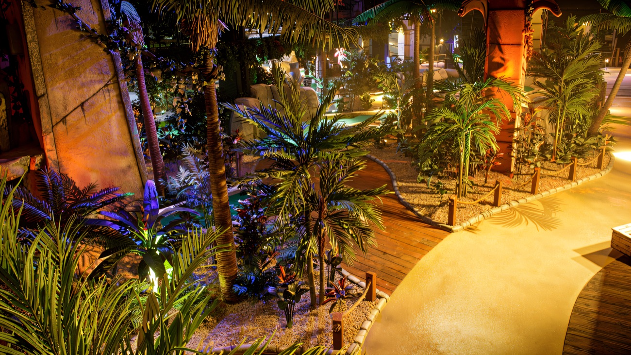 The palm-lined jungle walkway winding through Lost City Adventure Golf in Belfast