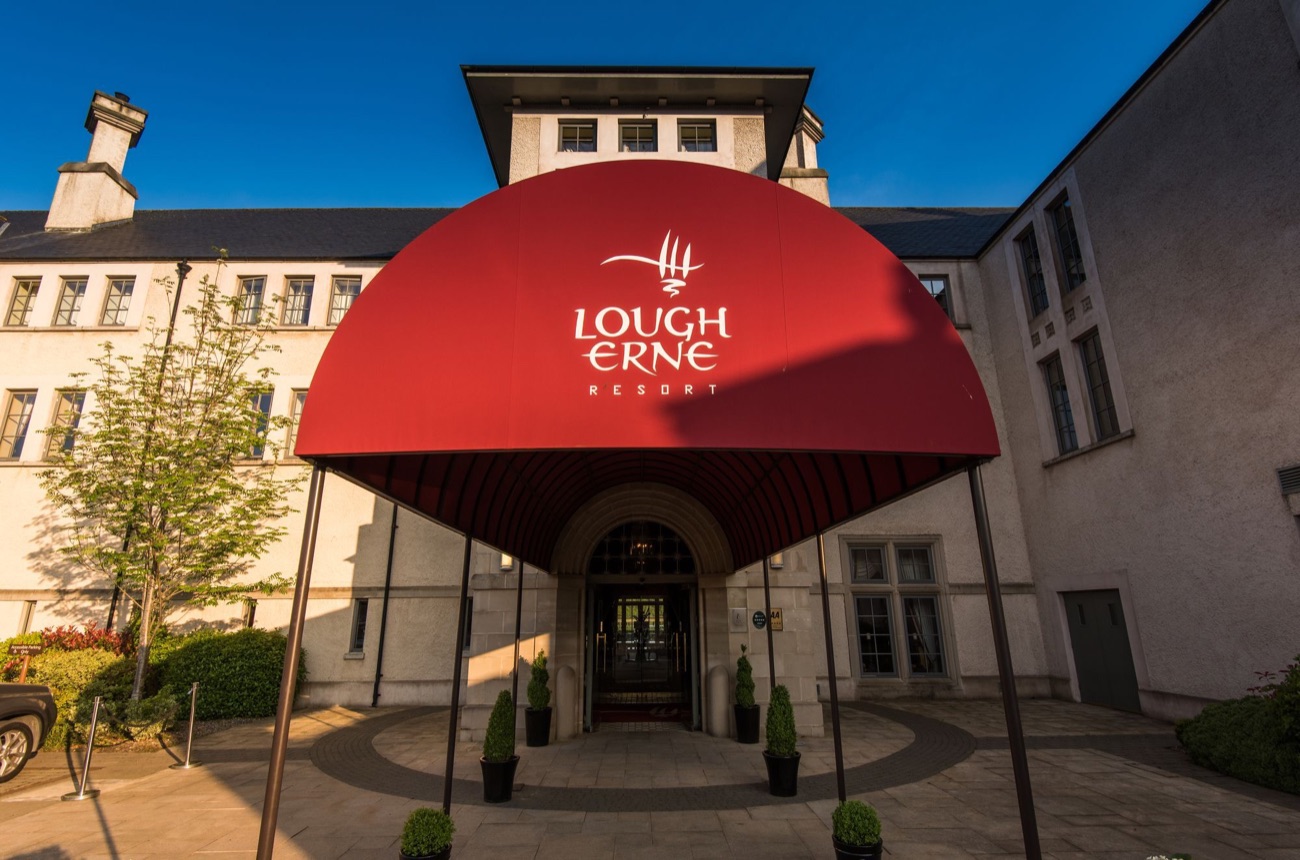The red arched entrance canopy of Lough Erne Resort, marked with the resort's crest