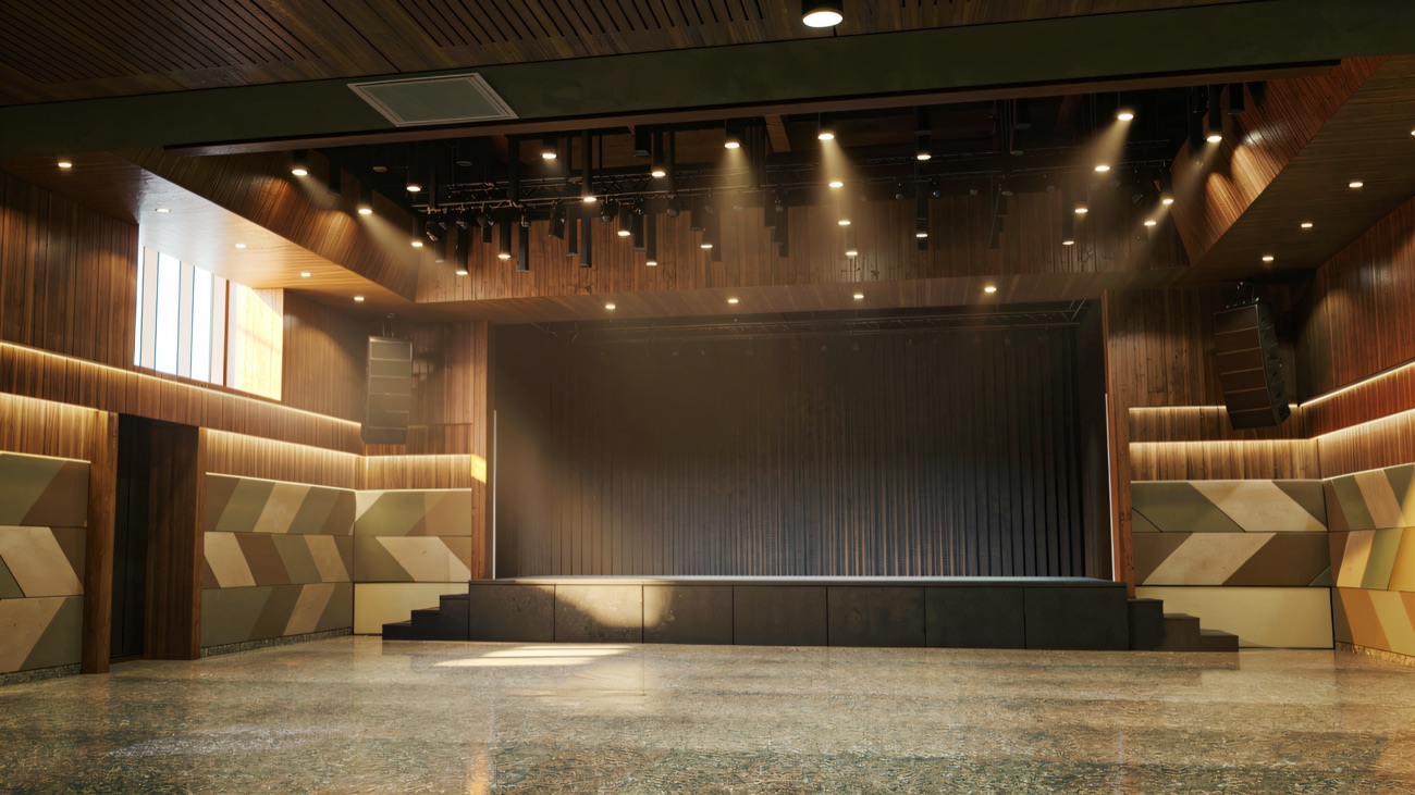 The empty hall and stage, lined with warm timber panelling
