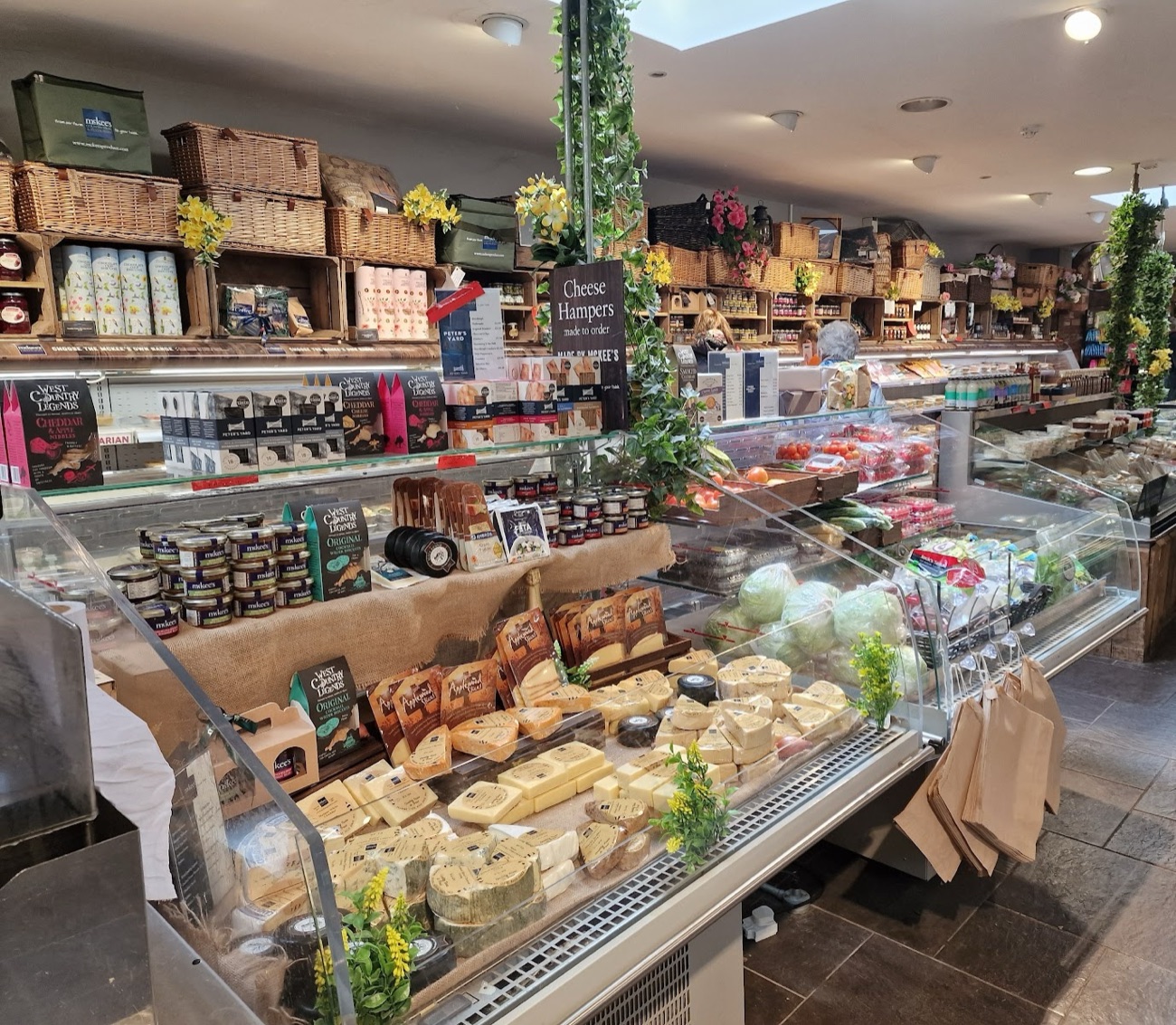 The cheese counter at McKee's with hampers and baskets stacked above it