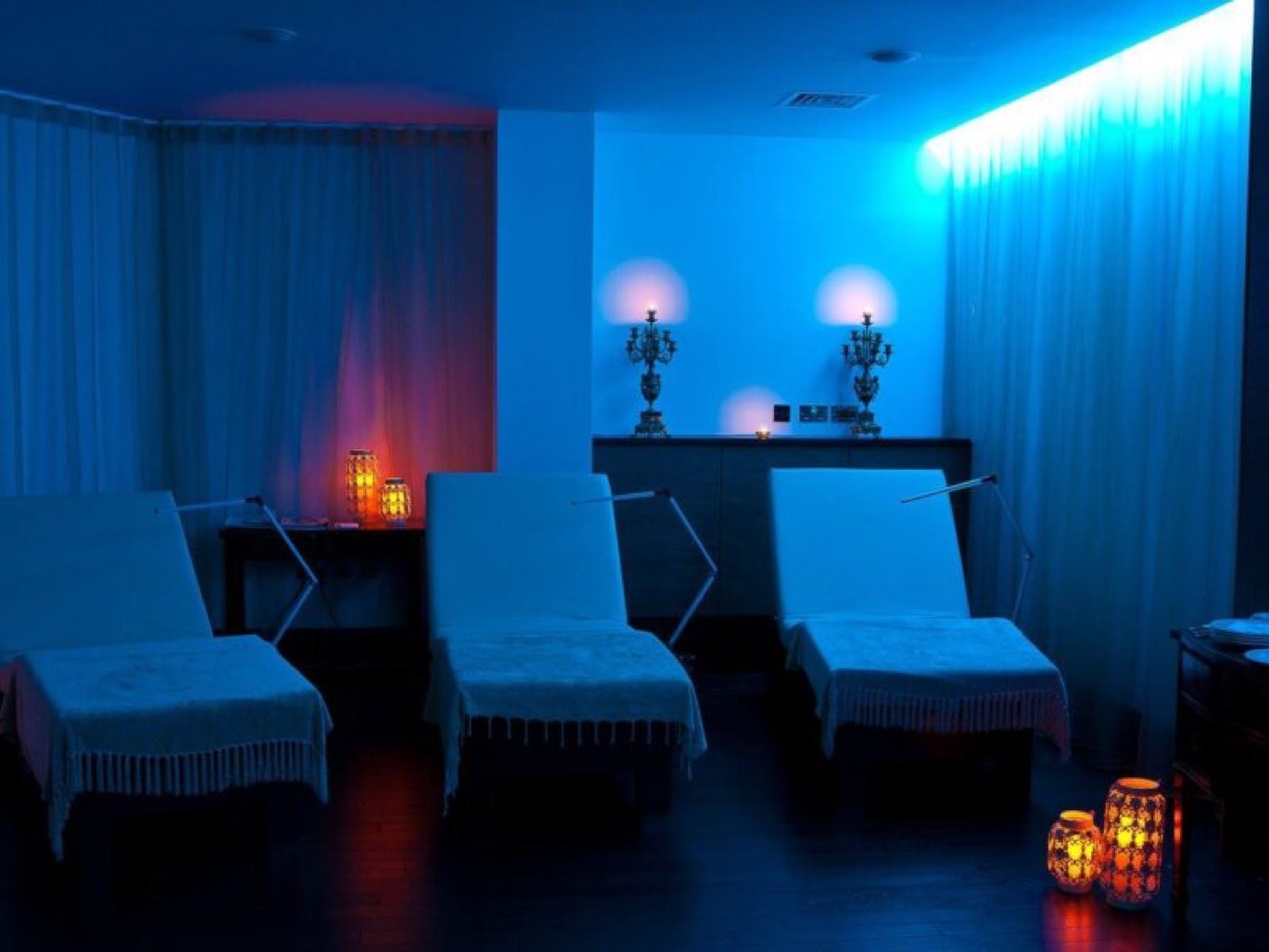 The relaxation room, with heated loungers and candlelight for winding down between treatments.