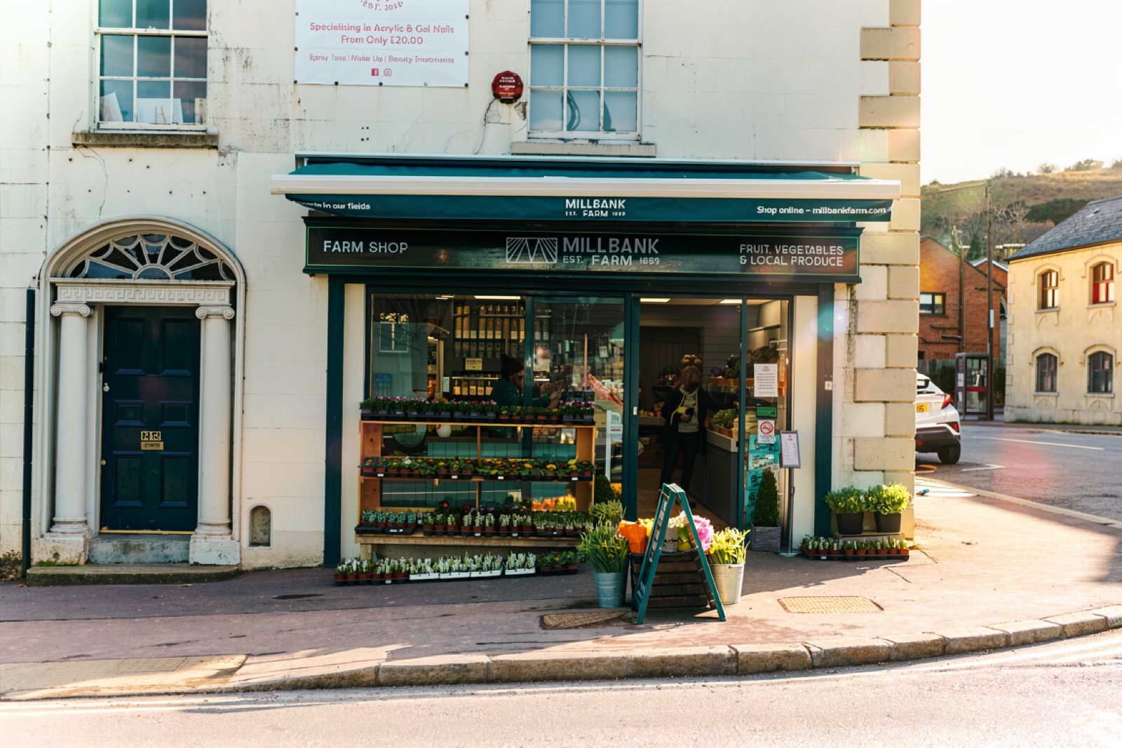 The vegetable display at Millbank Farm Shop, wooden crates of leeks, cabbage and carrots under hand-chalked price boards