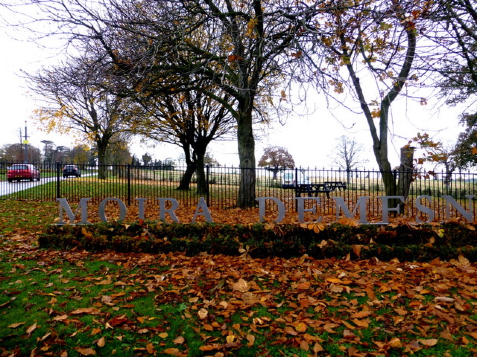 The Moira Demesne entrance sign with autumn parkland behind