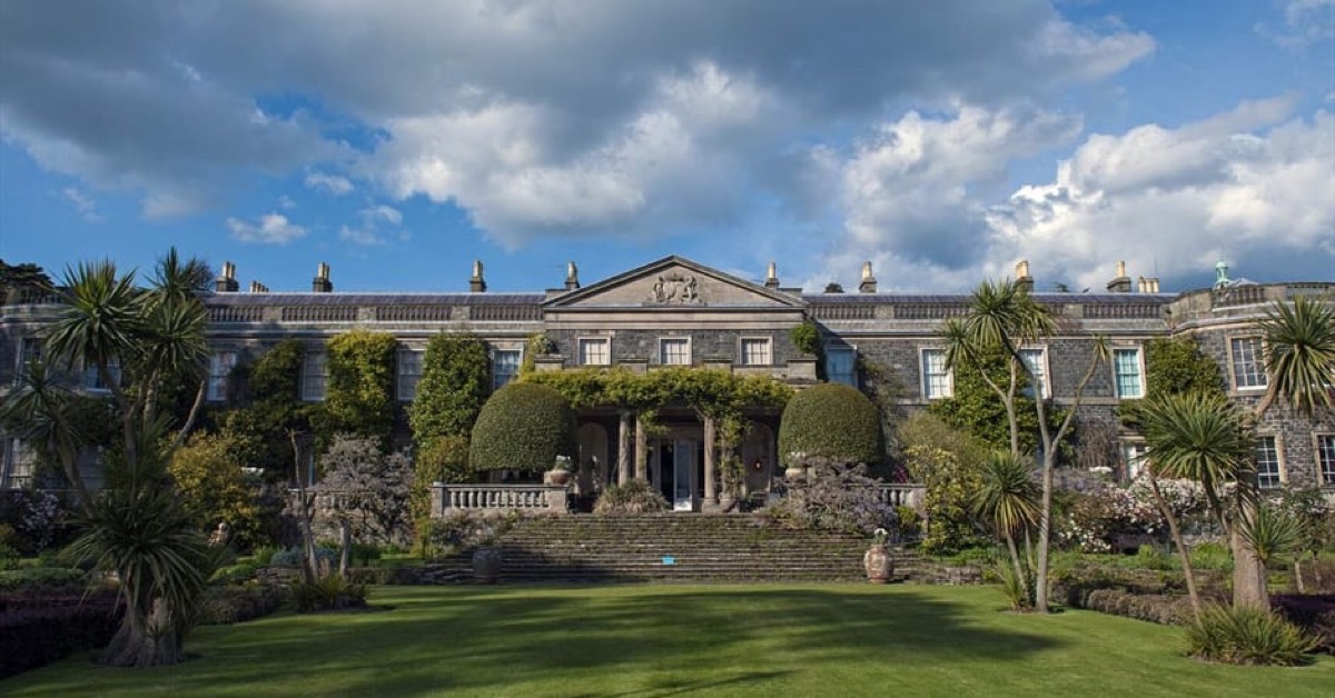 Mount Stewart house with palm trees and dramatic sky