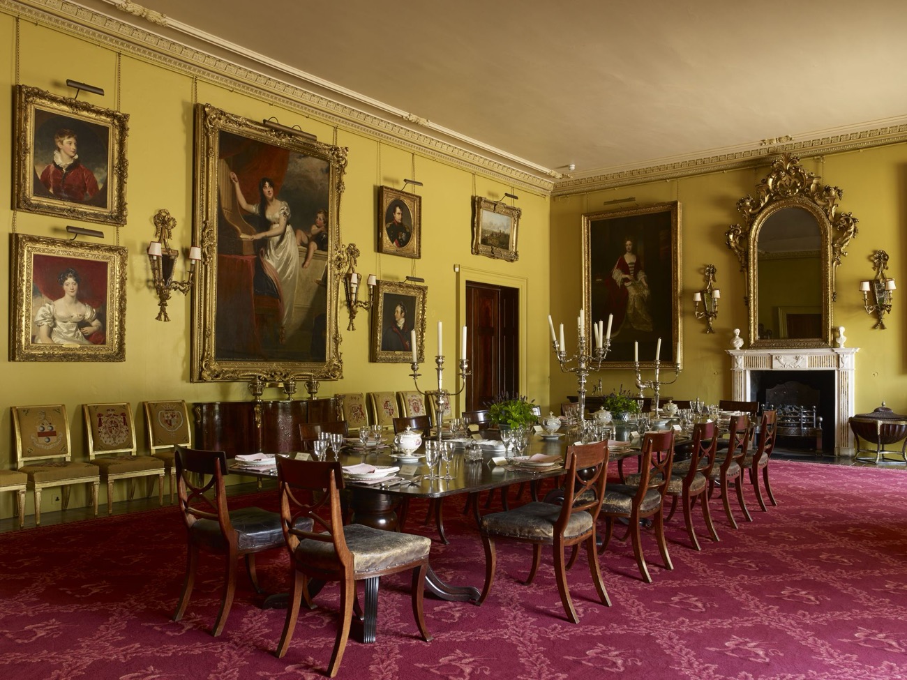 The grand dining room hung with family portraits