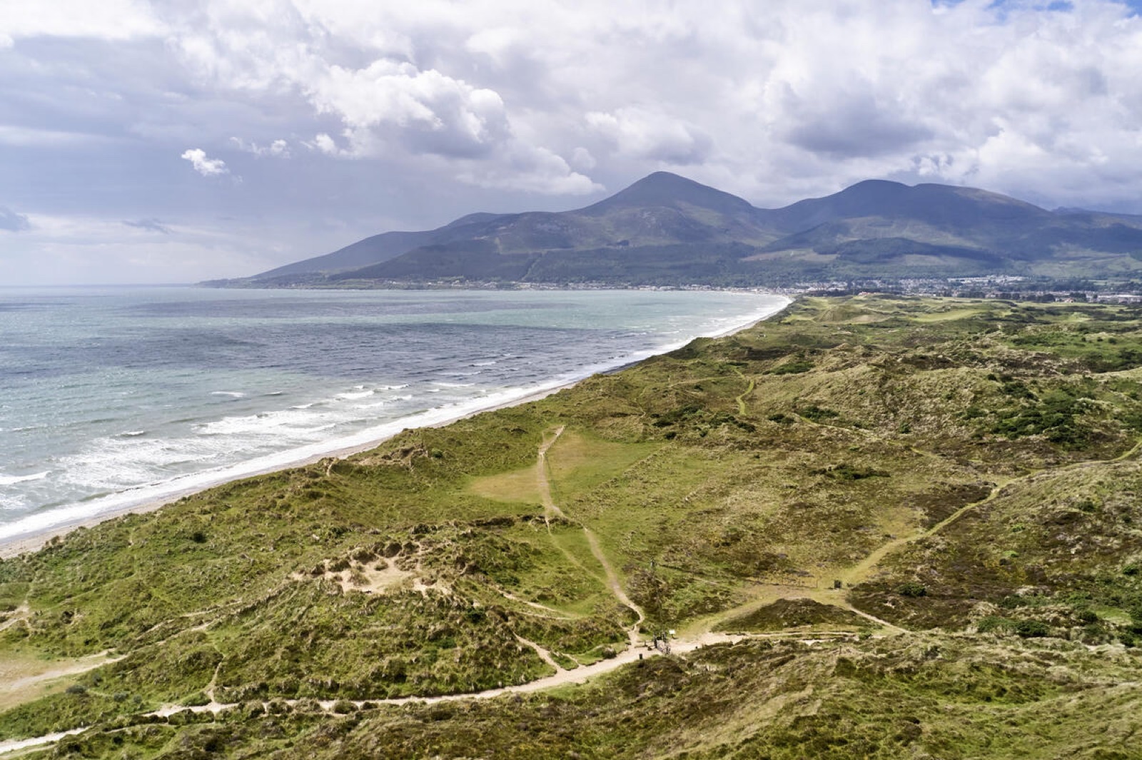 Aerial view of the Murlough dune system and beach curving toward the Mourne Mountains