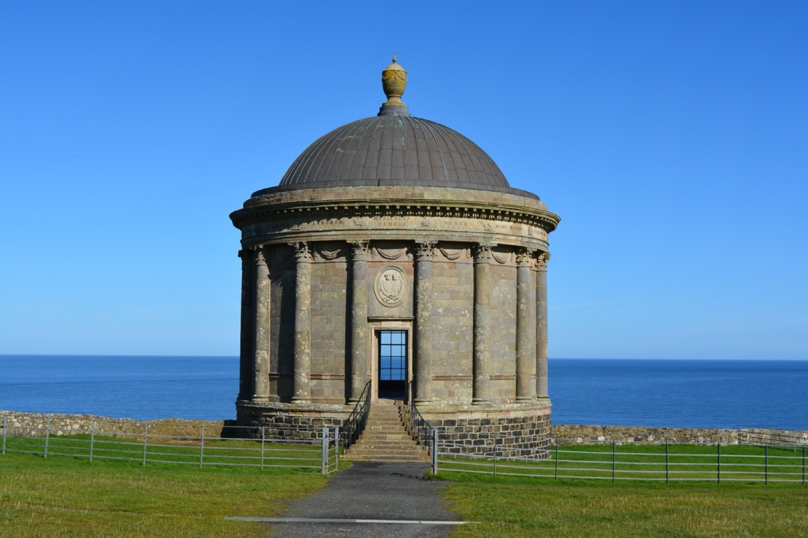 The round domed Mussenden Temple against a blue sky and the sea