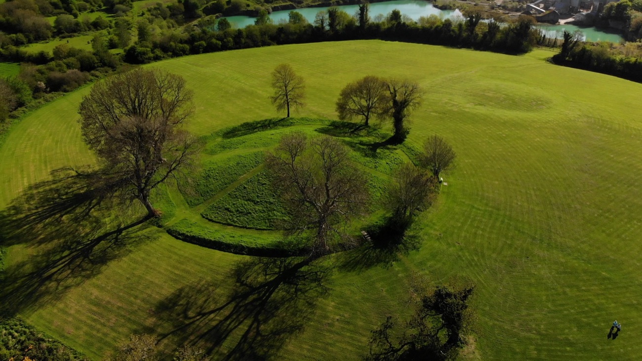 Closer aerial of the central mound and trees within the Navan Fort earthwork enclosure