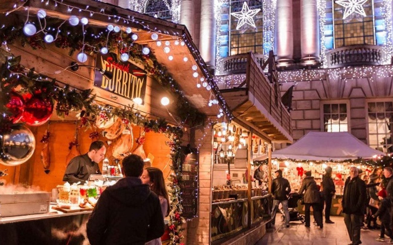 Wooden chalets and lights at the Belfast Christmas Market outside City Hall