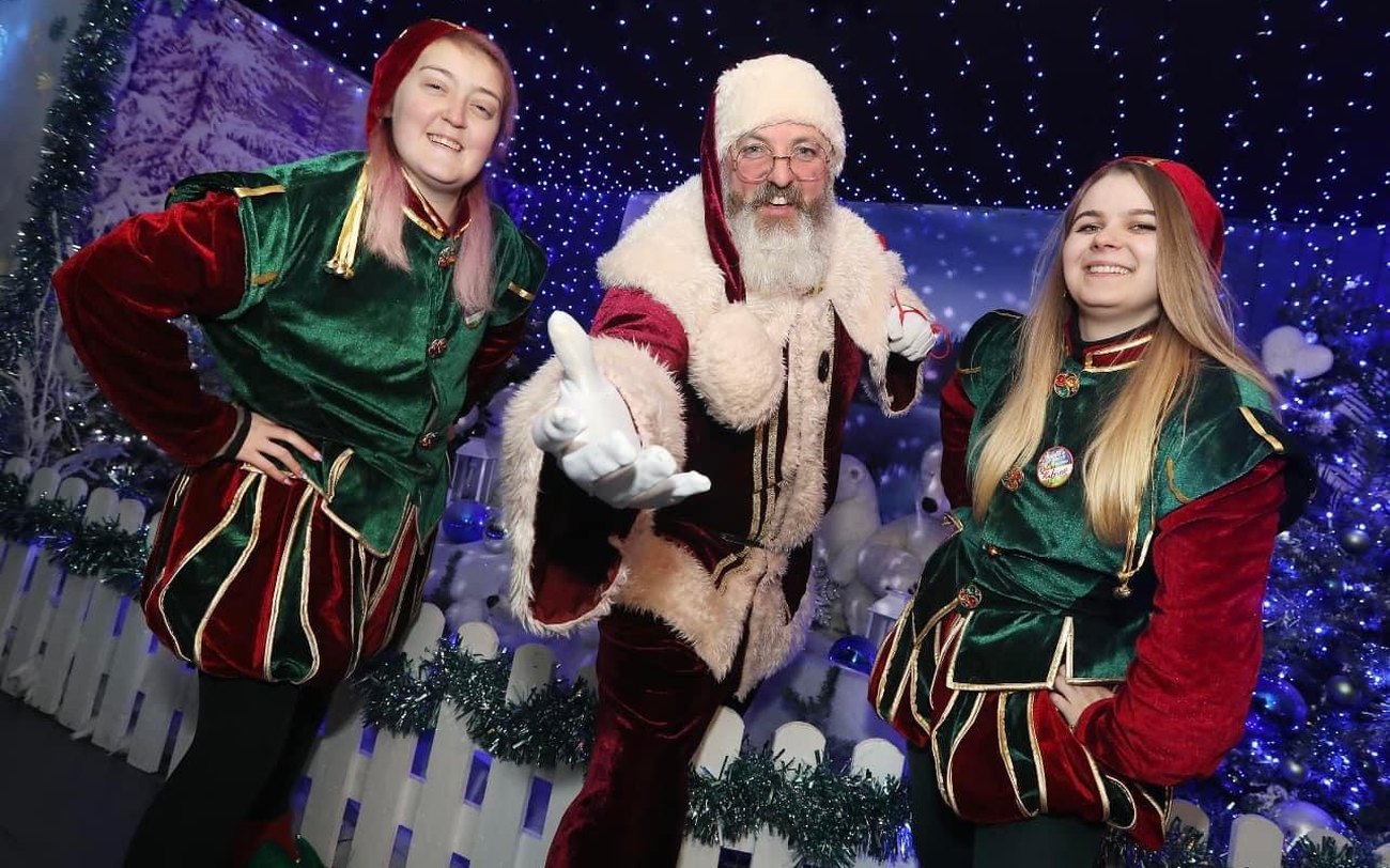 A child meeting Father Christmas in a festive grotto