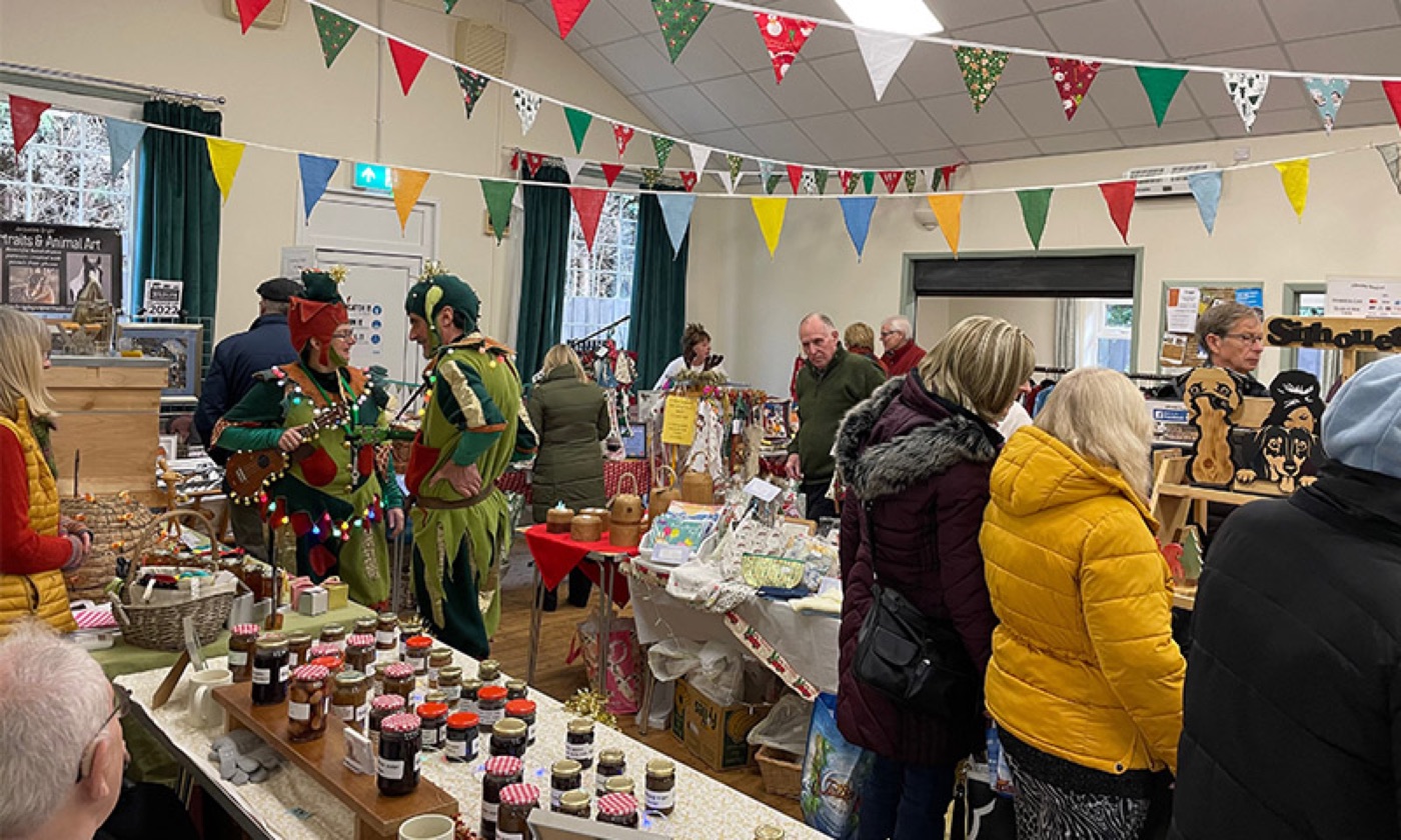 A church hall Christmas craft fair with handmade gift stalls