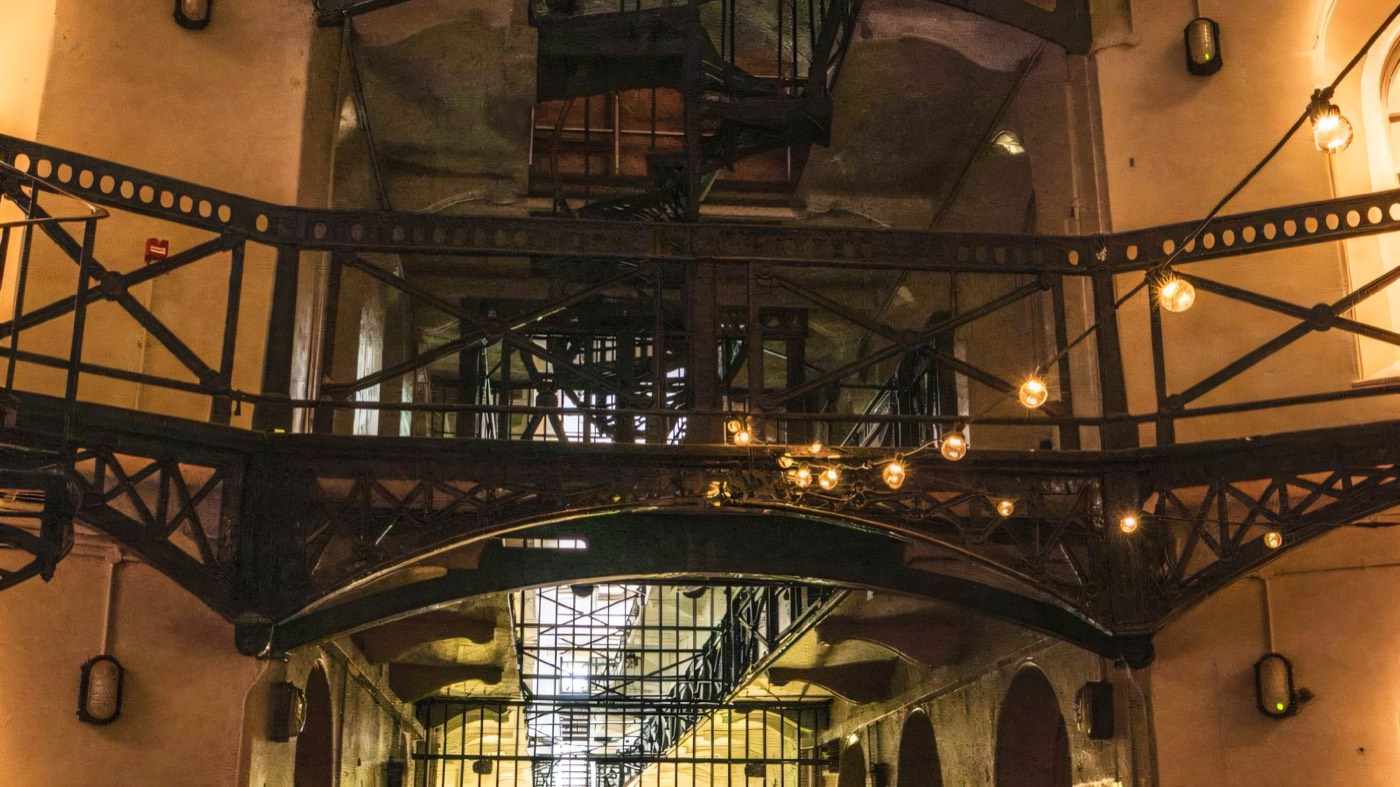 A dimly lit Victorian prison wing at Crumlin Road Gaol, Belfast