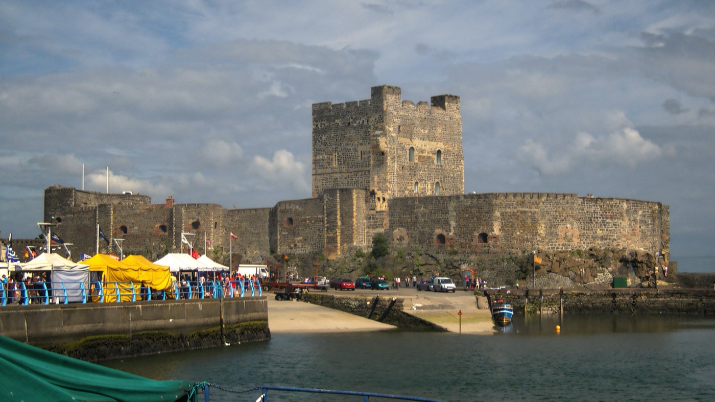 Carrickfergus Castle lit at night beside the water