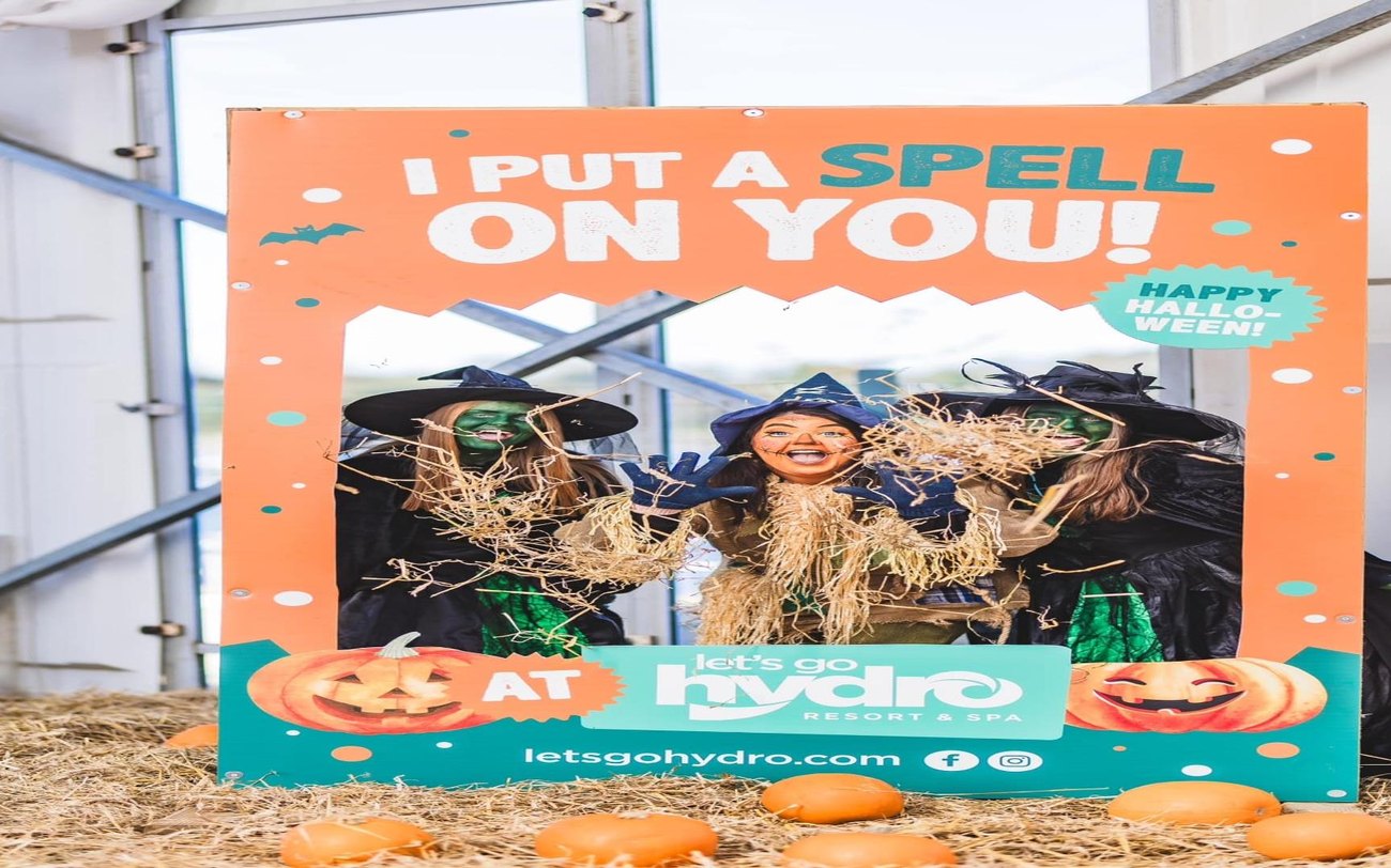 A lakeside pumpkin patch lit up at dusk at Let's Go Hydro