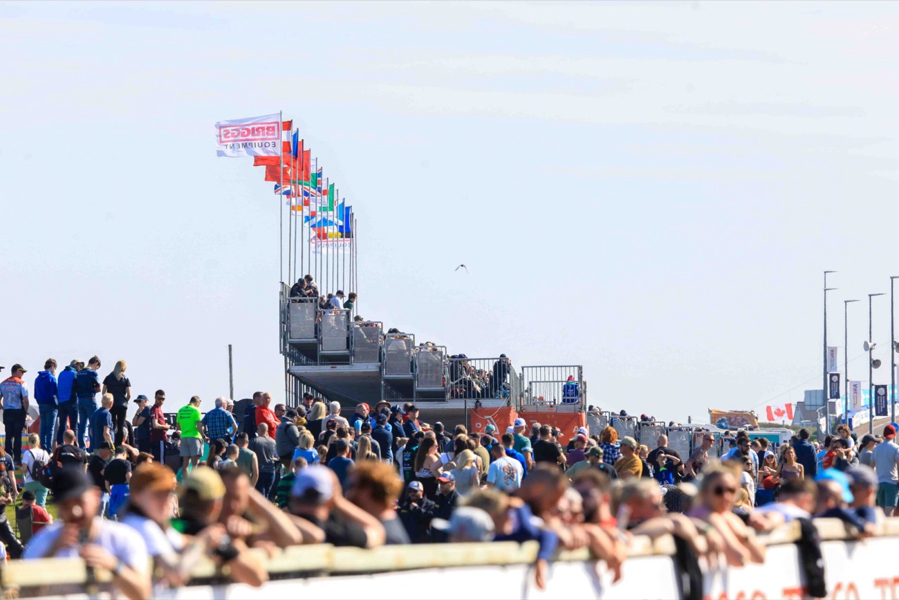 Spectators lining the banks under international flags watching the North West 200 on the coast