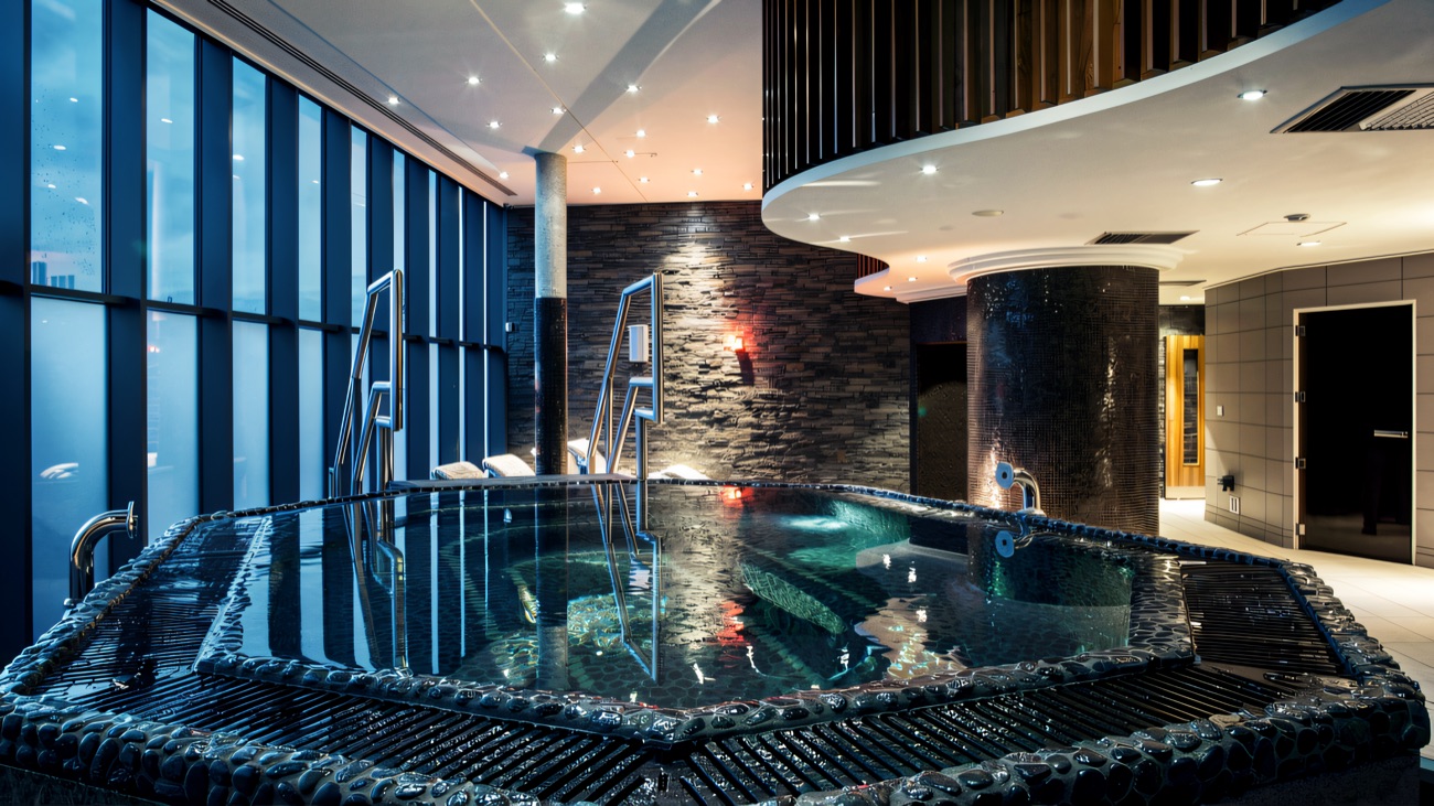 The warm spa pool with its curved seating and mood lighting