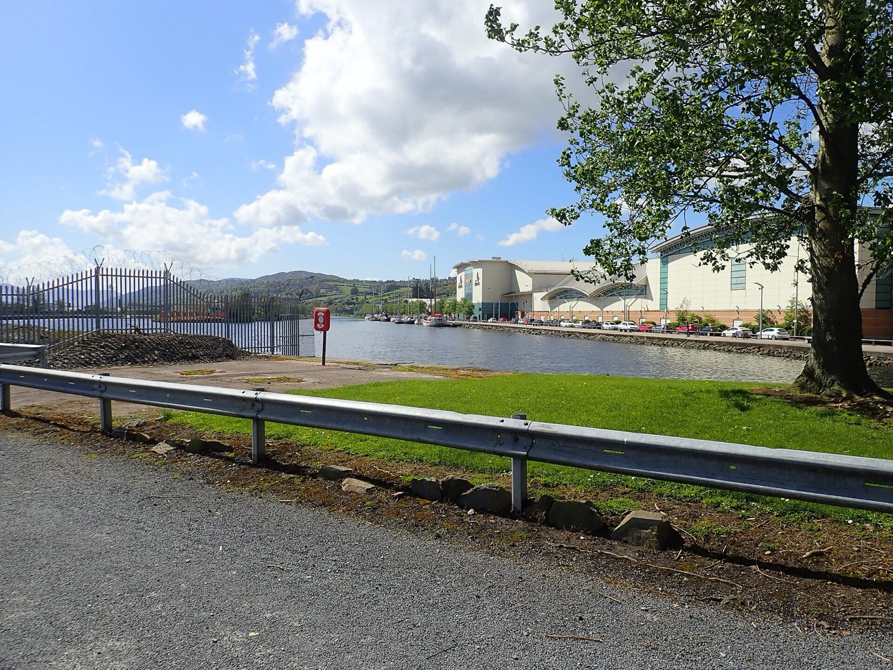 The Albert Basin and The Quays Shopping Centre seen from the leafy entrance to the Newry Greenway