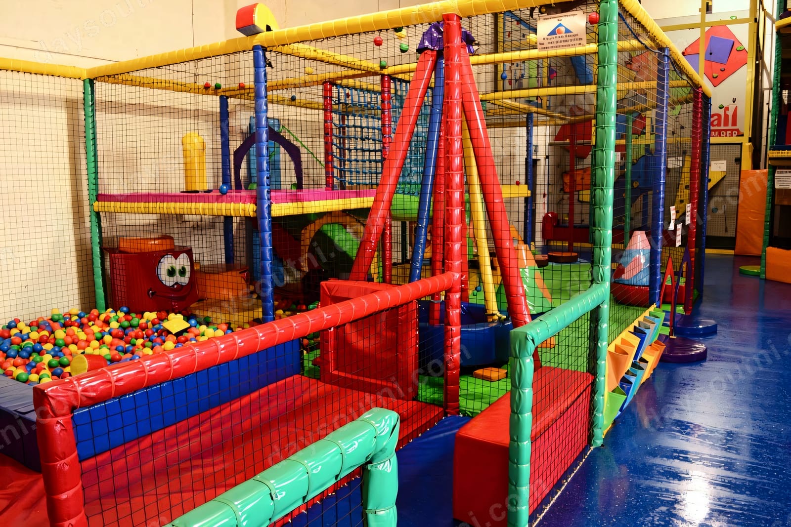 The colourful indoor soft play frame at Rascals in Newry, with a red-and-blue climbing frame, ball pit and netting