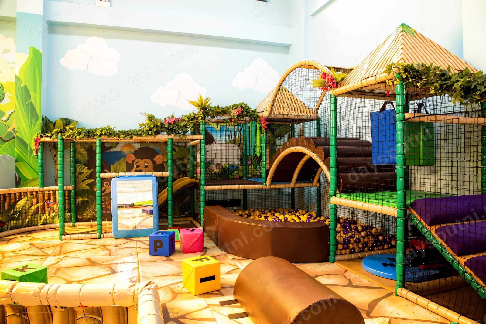 The jungle-themed three-tier soft play frame at Roar and Explore, Dunmurry, with a ball pit, safari hut and greenery