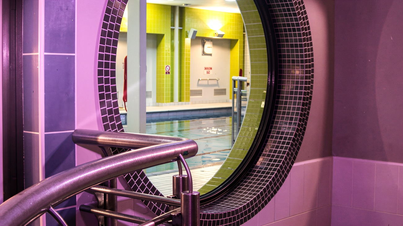 A round window looking through to the pool beyond