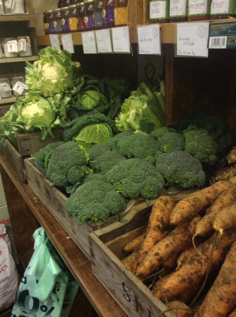 Cauliflower, broccoli and carrots piled in wooden crates
