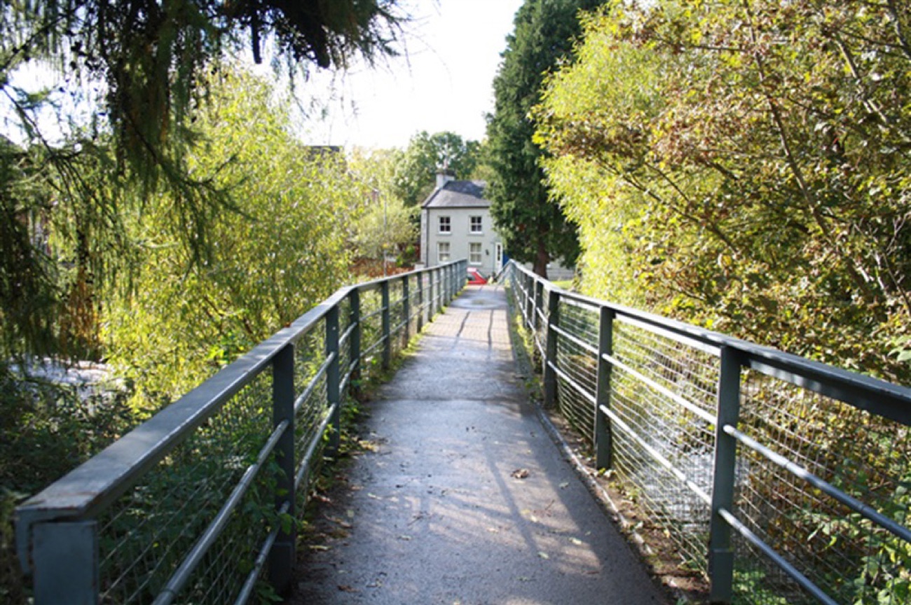 A metal footbridge crossing the River Bann in Solitude Park