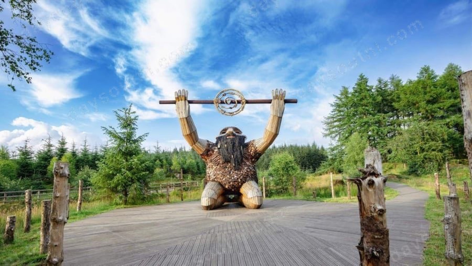 A giant timber sculpture holding a beam above its head in the Sperrins