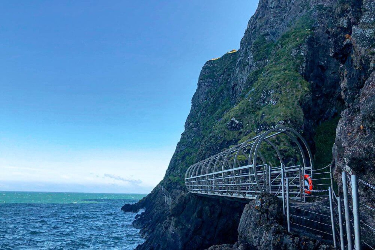 The Tubular Bridge reaching out over deep blue sea under a clear sky