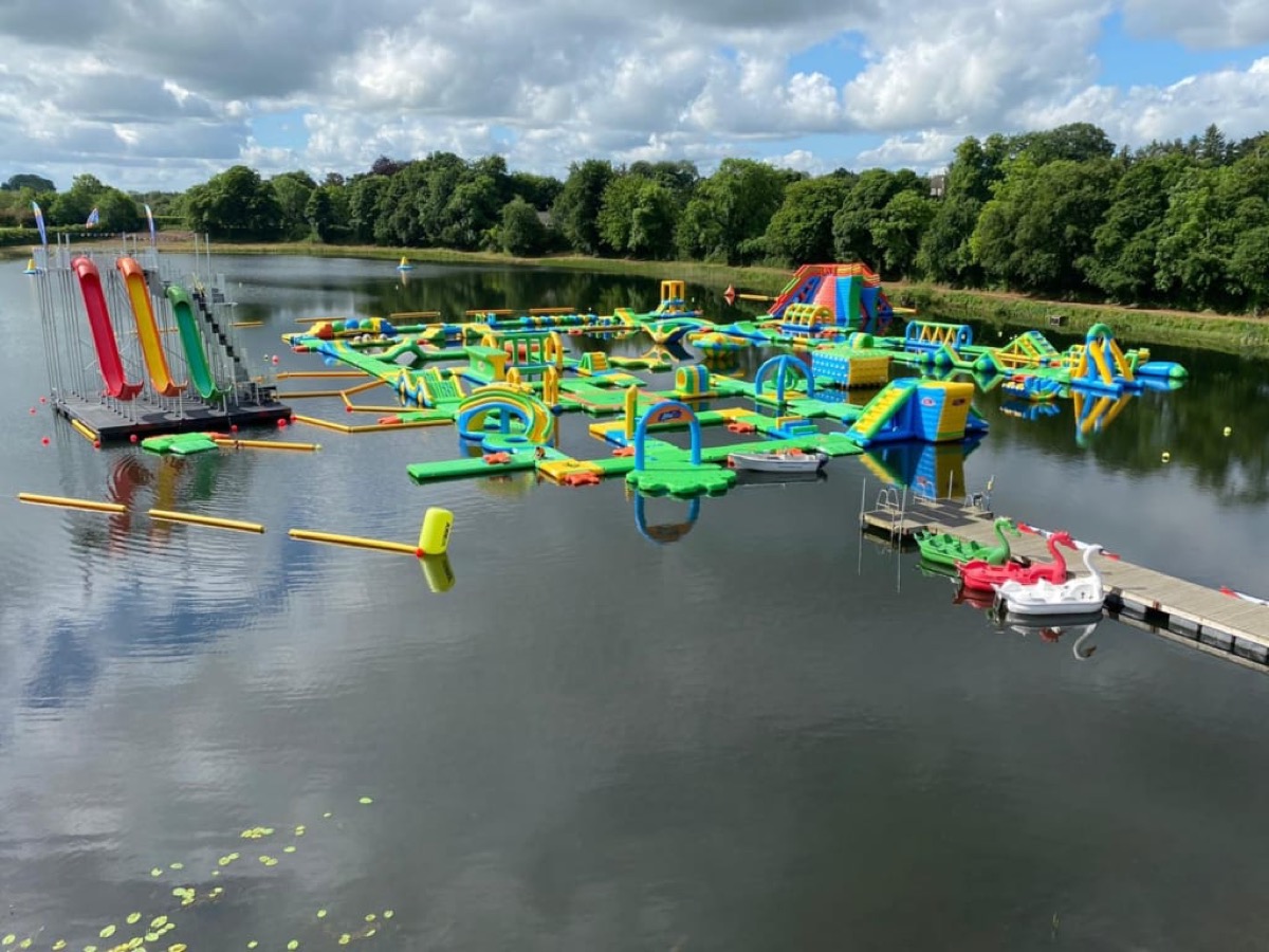 The colourful inflatable course and the tall slide tower
