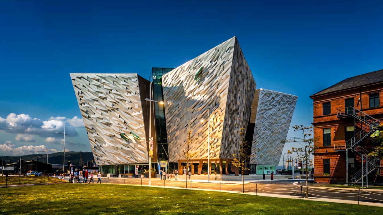 The silver angular hull-shaped building of Titanic Belfast in bright sunshine