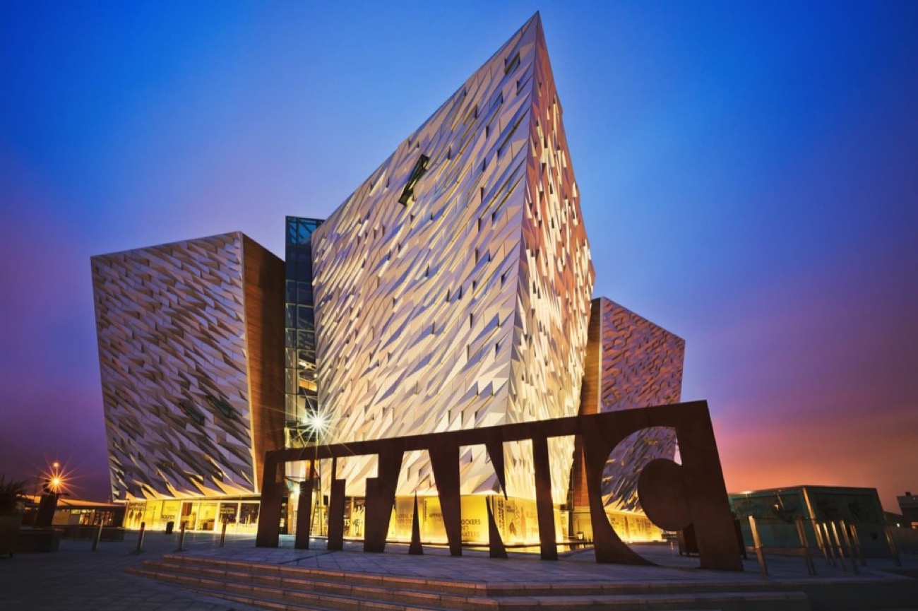 Titanic Belfast at sunset with the giant TITANIC sign
