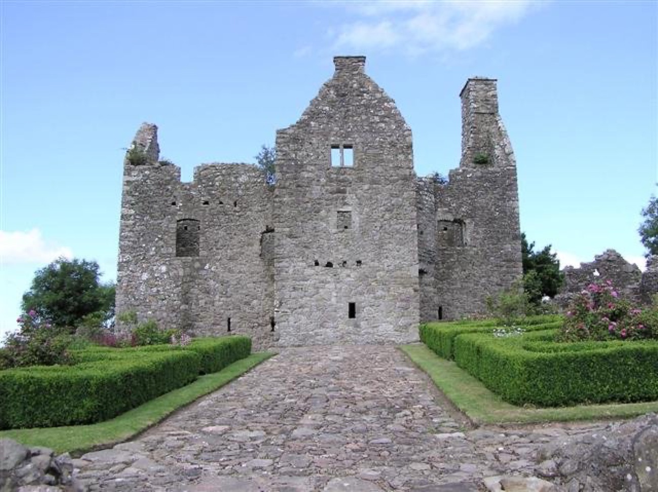 The cobbled path leading up through the recreated garden to the front of Tully Castle