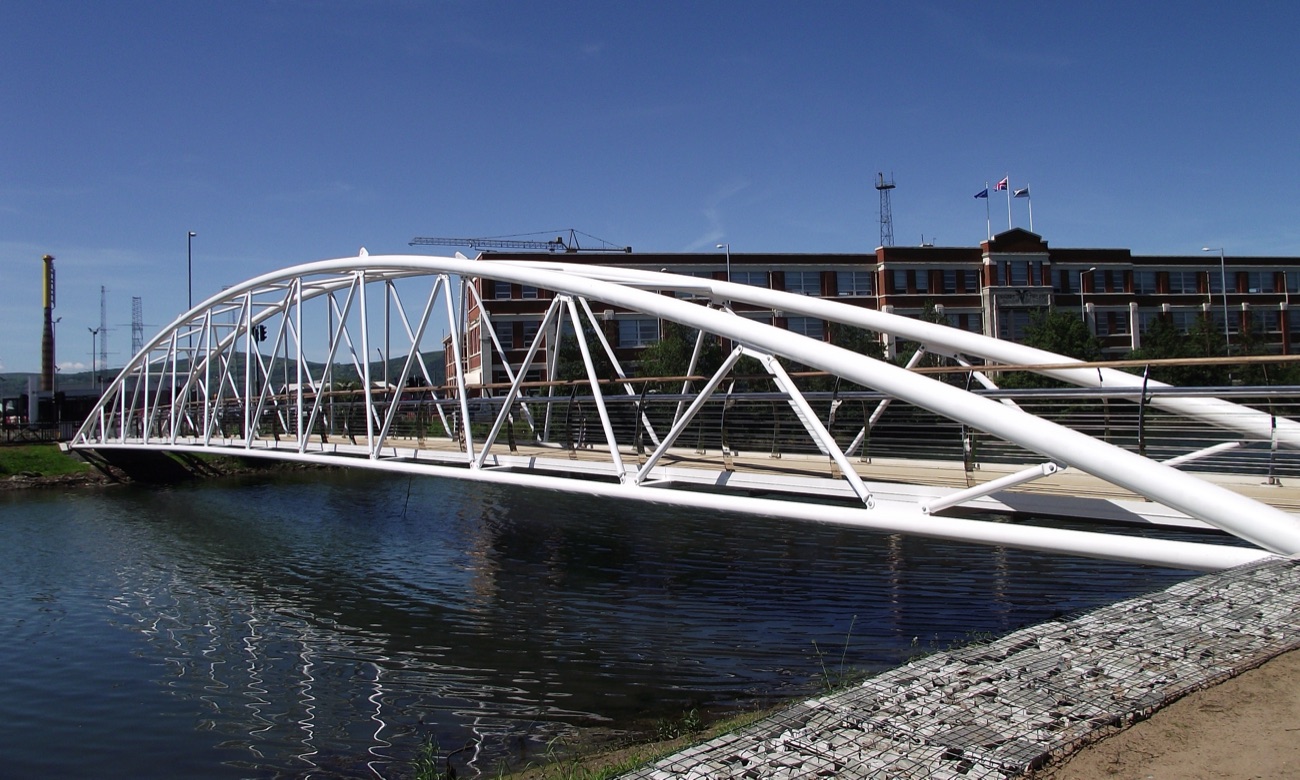 The white arched Sam Thompson Bridge crossing the water at Victoria Park