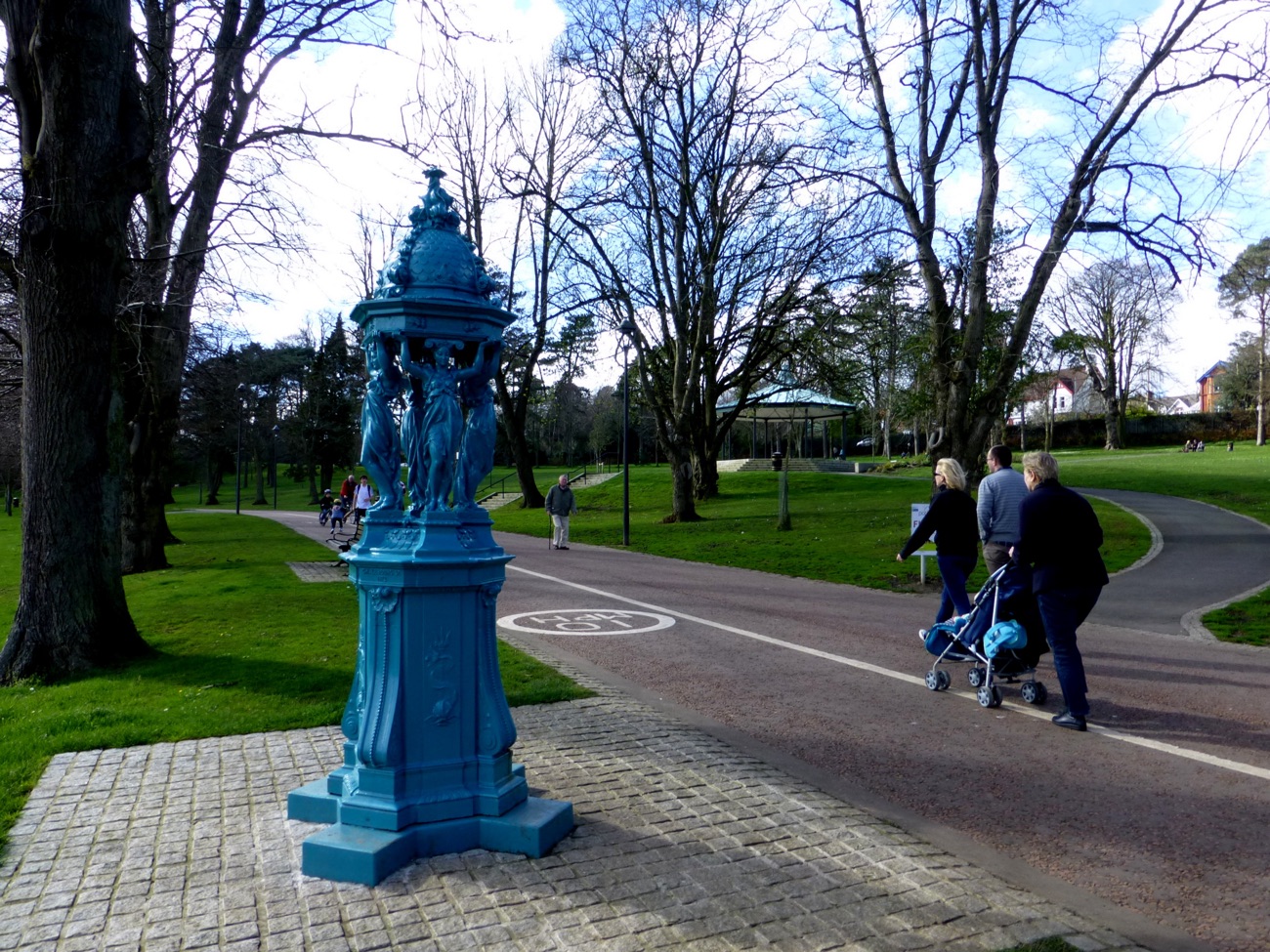 The blue Wallace drinking fountain with the bandstand on the green behind