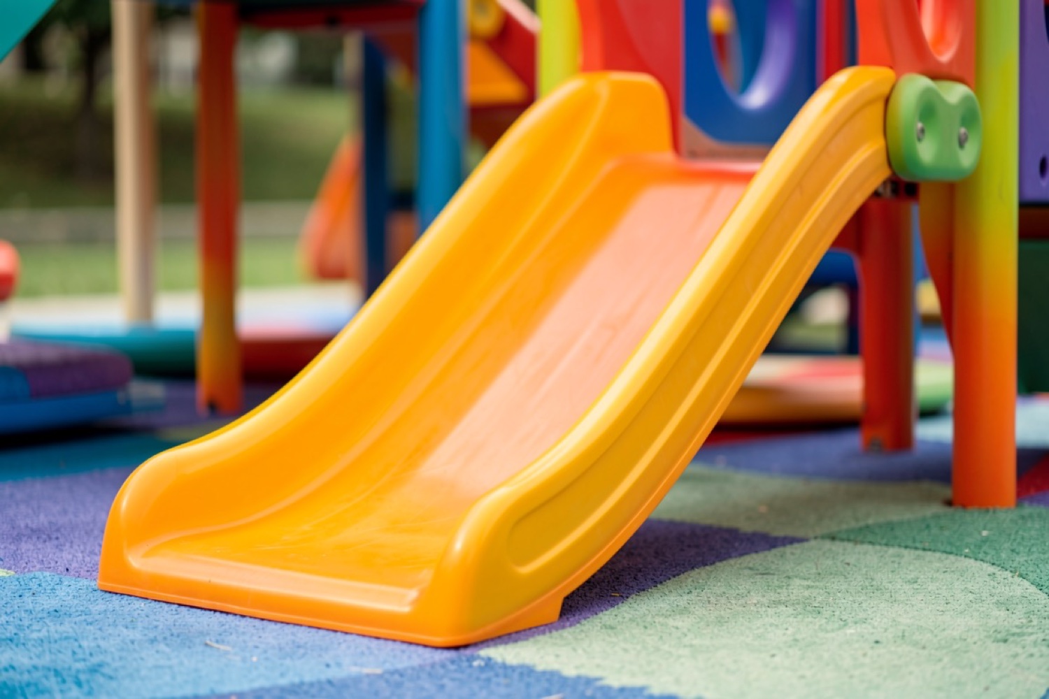 A bright orange soft-play slide (illustrative of an indoor soft-play centre)