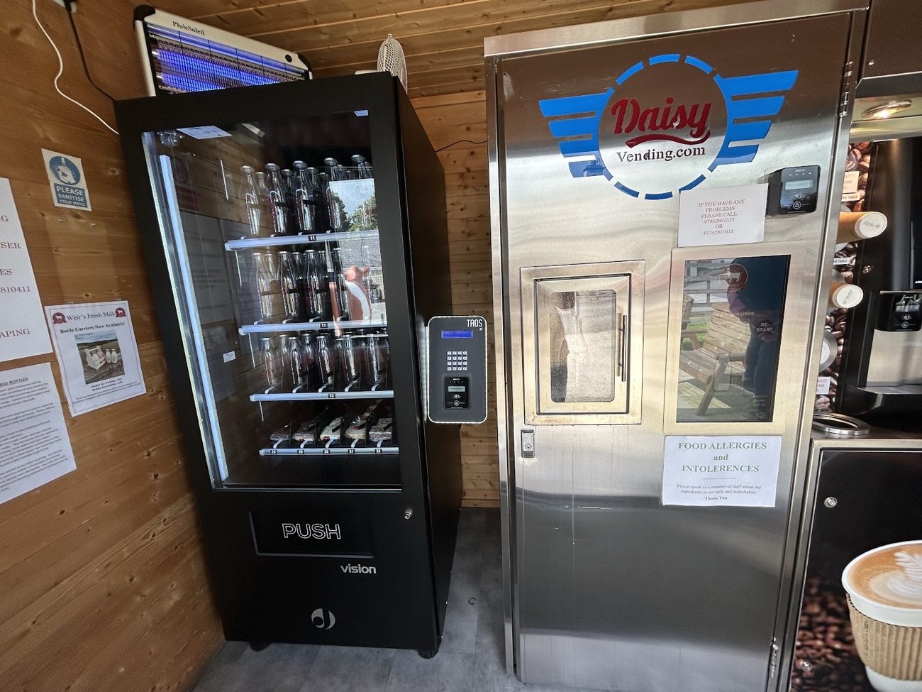 The milk vending machine inside the Weir Farms cabin, timber-lined with a coffee machine beside it