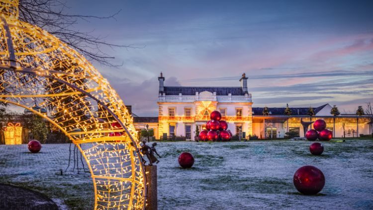 An illuminated arch of festive lights and giant baubles on the lawns at Galgorm at Christmas